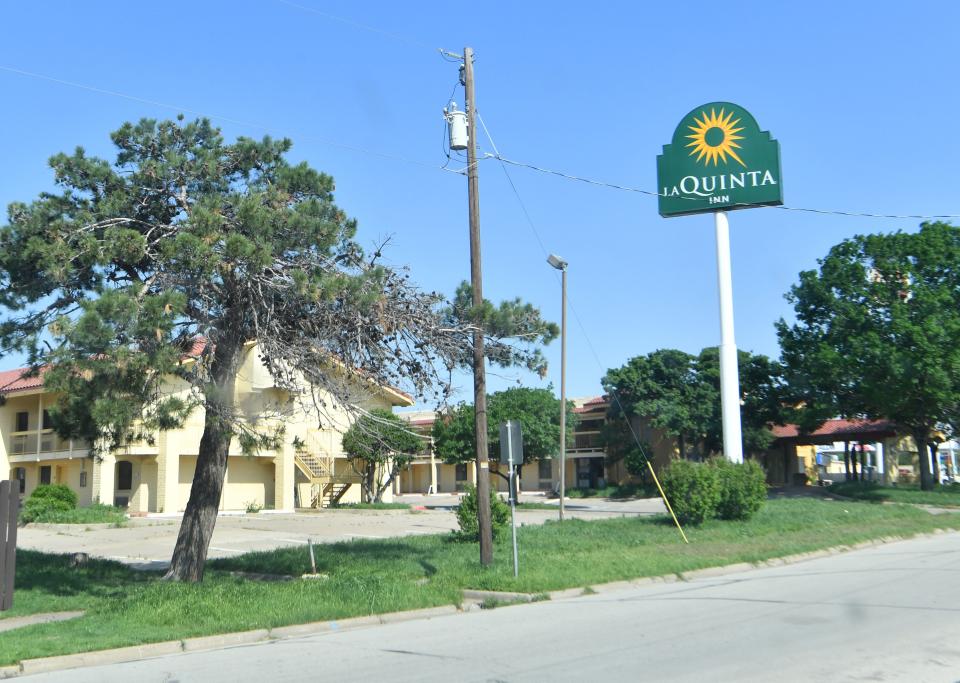 Two police officers were injured Tuesday during the apprehension of transients at the closed La Quinta Inn at 1128 Central E. Freeway