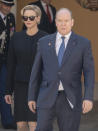 Princess Charlene, left, Prince Albert II of Monaco await Chinese President Xi Jinping at Monaco Palace, Sunday, March 24, 2019. Xi is paying the first state visit by a Chinese president to the tiny Mediterranean principality of Monaco on Sunday. (AP Photo/Olivier Anrigo)