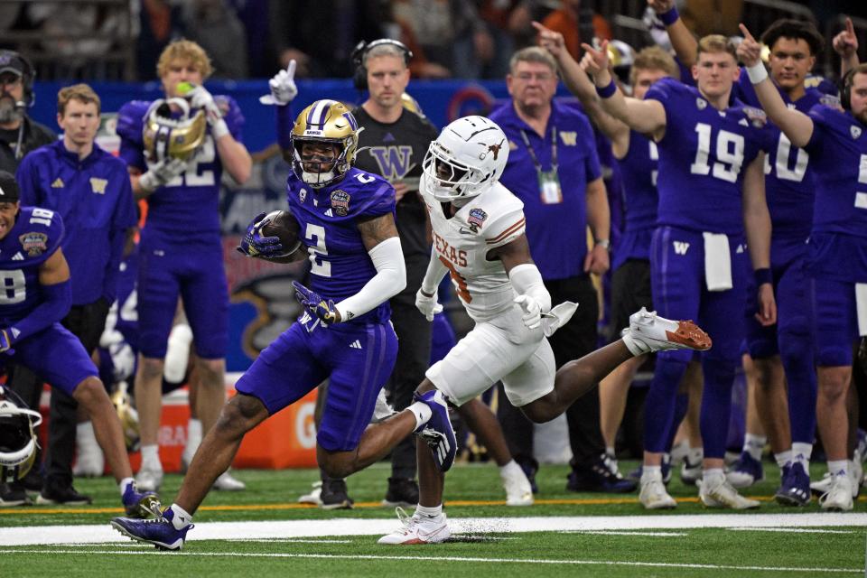 Washington wide receiver Ja'Lynn Polk (2) catches a pass against Texas defensive back Terrance Brooks (8) during their College Football Playoff semifinal game at the 2024 Sugar Bowl at Caesars Superdome.
