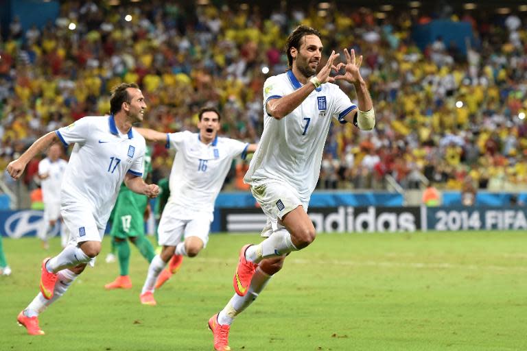 Greece's forward Georgios Samaras (C) celebrates scoring a penalty during a Group C football match between Greece and Ivory Coast at the Castelao Stadium in Fortaleza during the 2014 FIFA World Cup on June 24, 2014