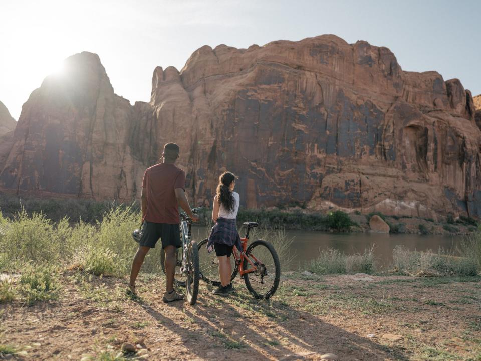 People standing outside in nature with a bike