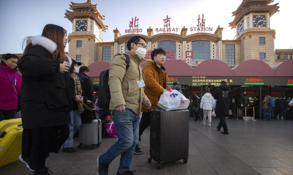 A traveller wears a face mask outside Beijing railway station