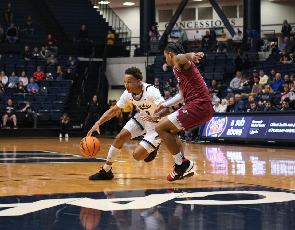 Monmouth's Jakari Spence drives against a Rider defender at OceanFirst Bank Center in West Long Branch on Dec. 16, 2023.