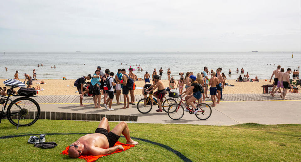 People enjoy the weather at St Kilda beach in Melbourne — that’s the caption