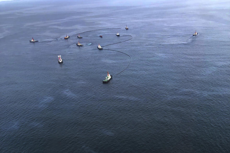 In this photo released by the Royal Thai Navy, an aerial view from a navy plane shows cleanup efforts of the latest oil spill off the coast of Rayong, eastern Thailand, Friday, Feb. 11, 2022. Thai authorities scrambled Friday to contain the country's second oil spill in less than three weeks in the Gulf of Thailand off the eastern province of Rayong, with an estimated 5,000 liters believed to have leaked. On Jan. 25, at least 20,000 liters spilled into the sea. (Royal Thai Navy via AP)