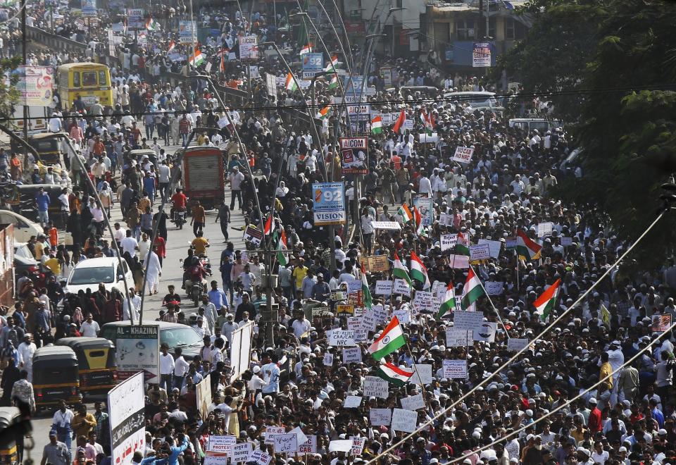 Indians march during a protest against the Citizenship Act in Mumbai, India, Wednesday, Dec. 18, 2019. India's Supreme Court on Wednesday postponed hearing pleas challenging the constitutionality of the new citizenship law that has sparked opposition and massive protests across the country. (AP Photo/Rajanish Kakade)