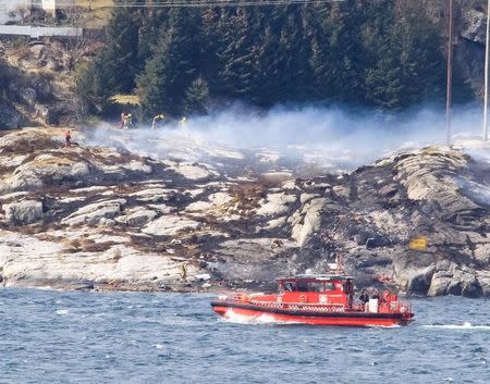 Rescuers work at a site where a helicopter has crashed, west of the Norwegian city of Bergen April 29, 2016. NTB Scanpix/Bergens Tidende/via REUTERS