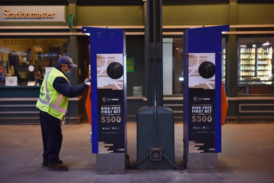 A NJ Transit employee at the Hoboken Terminal disinfects areas around the terminal during morning rush hour in Hoboken, N.J., on March 16, 2020.