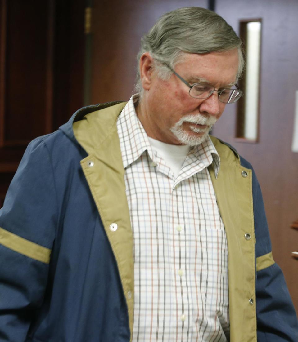 James Holmes father Robert Holmes leaves a hearing for his son at district court in Centennial, Colo., on Friday Jan. 31, 2014. Holmes has pleaded not guilty by reason of insanity to charges of killing 12 people and injuring 70 at a Denver-area movie theater in July 2012. Prosecutors are seeking the death penalty. (AP Photo/Ed Andrieski, Pool)