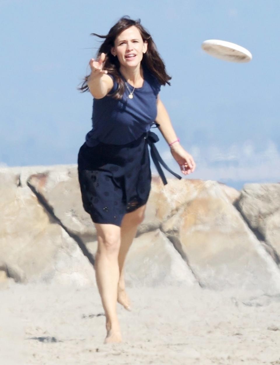 <p>Jennifer Garner plays a round of frisbee with a friend on the beach on Sunday in Santa Barbara.</p>