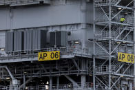 People work on the substation for the South Fork Wind farm, Thursday, Dec. 7, 2023, 35 miles east of Montauk Point, N.Y. A turbine at the commercial-scale offshore wind farm is producing power for the U.S. electric grid for the first time. (AP Photo/Julia Nikhinson)