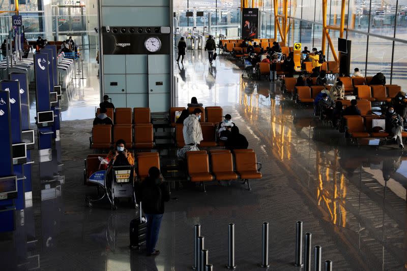 Travellers wait at Beijing Capital International Airport