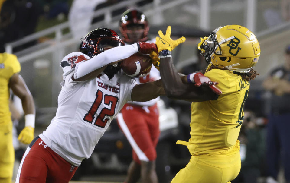 Texas Tech defensive back Bralyn Lux (12) breaks up a pass intended for Baylor wide receiver Ketron Jackson Jr., right, in the first half of an NCAA college football game, Saturday, Oct. 7, 2023, in Waco, Texas. (Rod Aydelotte/Waco Tribune-Herald, via AP)