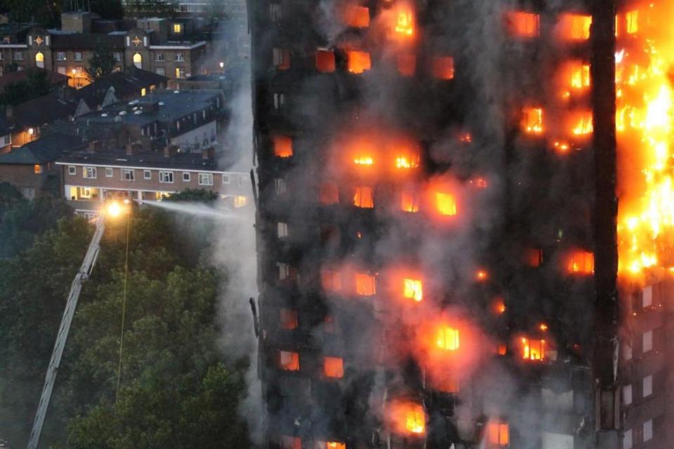 Firefighters work at the site of the Grenfell Tower fire (Jeremy Selwyn)