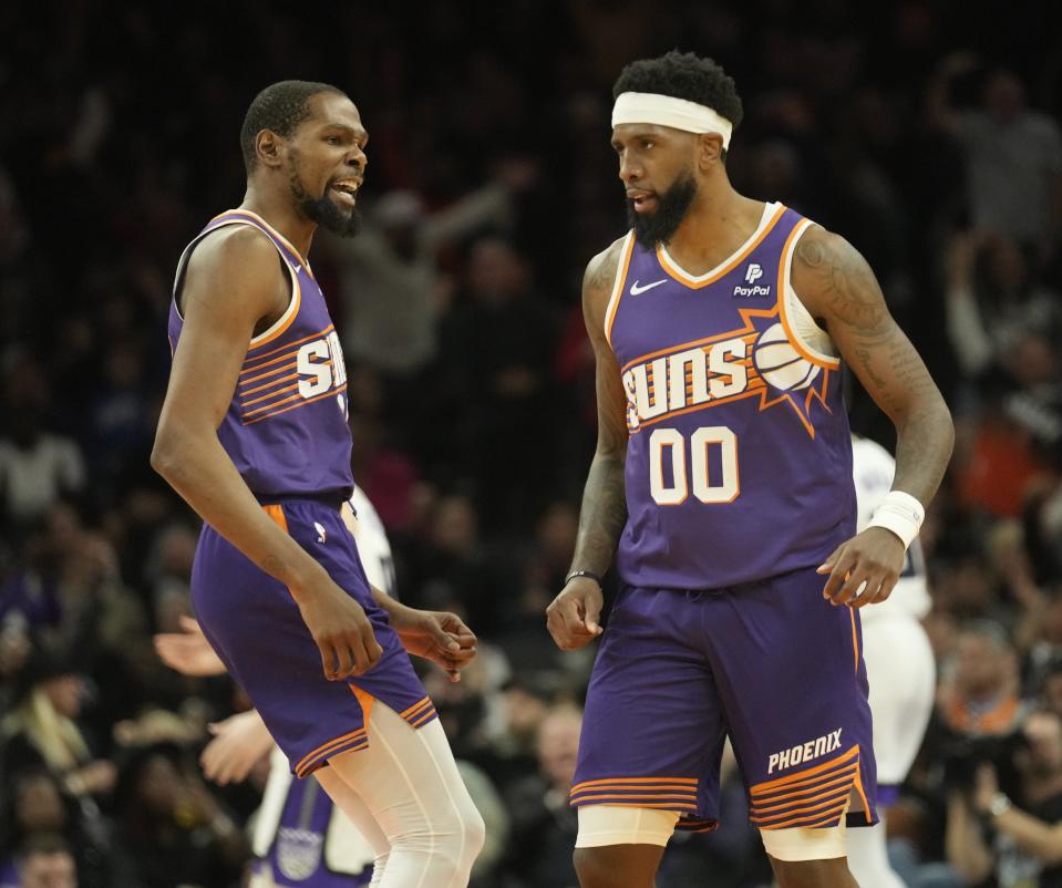 Phoenix Suns forward Kevin Durant (35) congratulates forward Royce O'Neale (00) after a three-pointer against the Sacramento Kings during the fourth quarter at Footprint Center in Phoenix on Feb. 13, 2024.