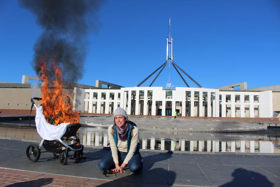 A supplied image shows a woman with a burning pram during an Extinction Rebellion protest 