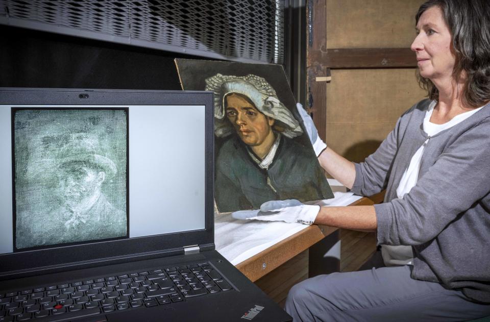 Senior Conservator Lesley Stevenson views Head of a Peasant Woman alongside an x-ray image of the hidden Van Gogh self-portrait.   / Credit: Neil Hanna