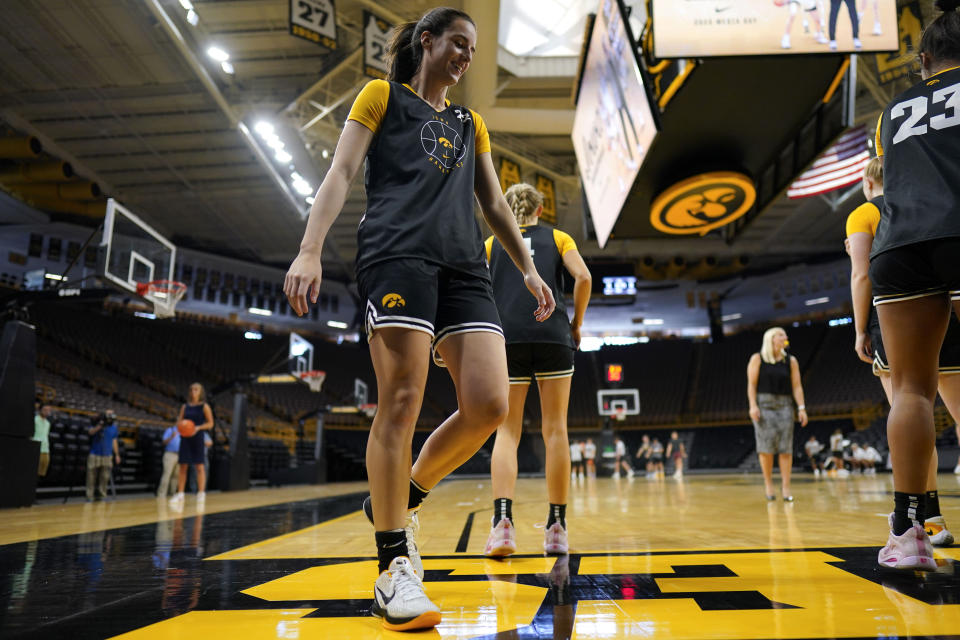 Iowa guard Caitlin Clark walks on the court during practice after Iowa's NCAA college basketball media day, Oct. 4, 2023, in Iowa City, Iowa. Clark is embracing her role as an ambassador for the game after she led Iowa to the NCAA championship game last season. She enters this season with 90 straight double-figure scoring games and a 27.3-point career average. (AP Photo/Charlie Neibergall)