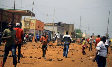 Demonstrators walk near a road barricade during protests over their exclusion from the presidential election in Beni, Democratic Republic of Congo December 28, 2018. REUTERS/Samuel Mambo