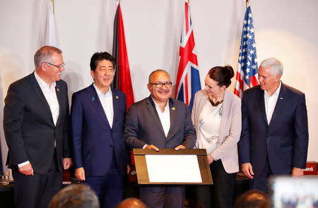 Papua New Guinea's Prime Minister Peter O' Neill, U.S. Vice President Mike Pence, Australia's Prime Minister Scott Morrison, New Zealand's Prime Minister Jacinda Ardern and Japan's Prime Minister Shinzo Abe pose for a photo during the signing of a joint electricity deal between Australia, Japan, New Zealand, United States for Papua New Guinea, during the APEC Summit in Port Moresby, Papua New Guinea November 18, 2018. REUTERS/David Gray