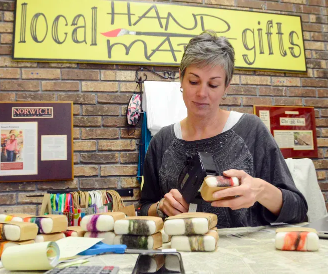 Erica Sullivan-Corbett is pictured preparing for last year's Small Business Saturday, at her store Small Potatoes in Norwich, Connecticut.