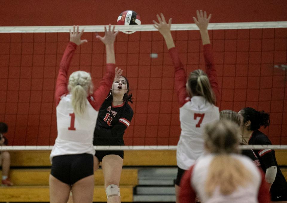 Mia Costas of South Fort Myers hits over Evangelical Christian School defenders on Thursday, October 13, 2022, at South Fort Myers High School.