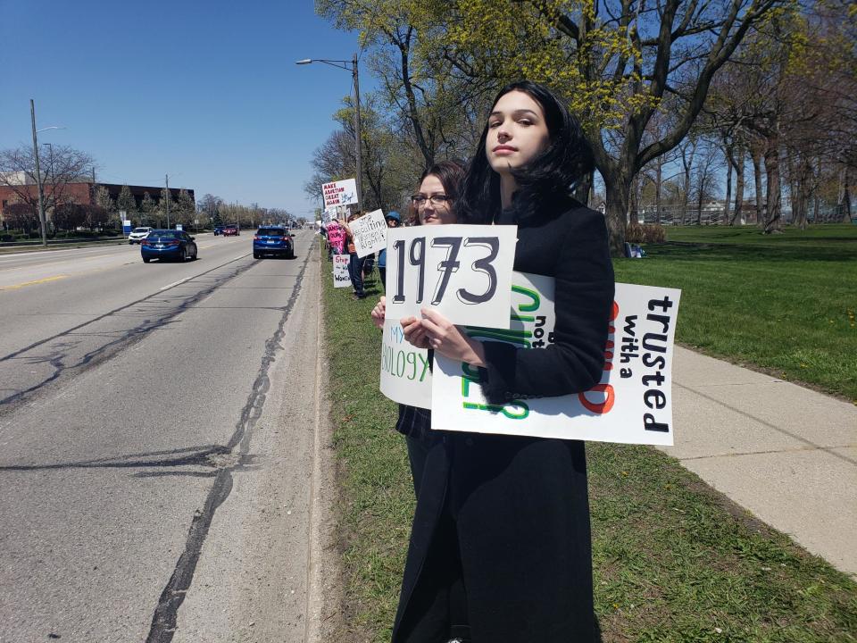 Sophie Frank, 18, of Fort Gratiot, holds a sign at an abortion rights demonstration in Pine Grove Park Saturday, May 7, 2022.