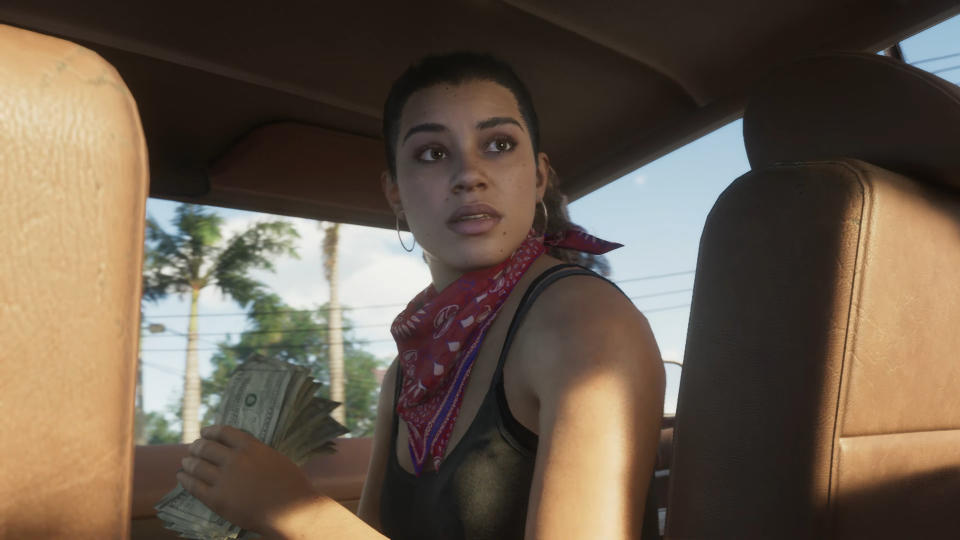 gta 6 trailer - Lucia in the front passenger seat, holding a presumably-stolen wad of cash