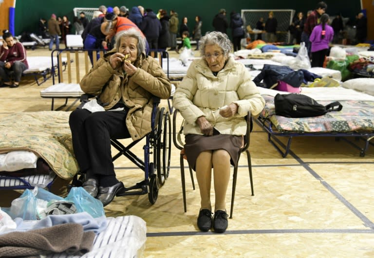 Two elderly women sit in a tent set up for the residents of Montereale after a 5.7-magnitude earthquake struck the Italian region, on January 18, 2017