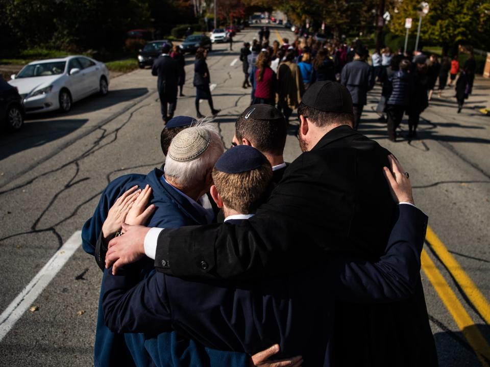 Mourners embrace.