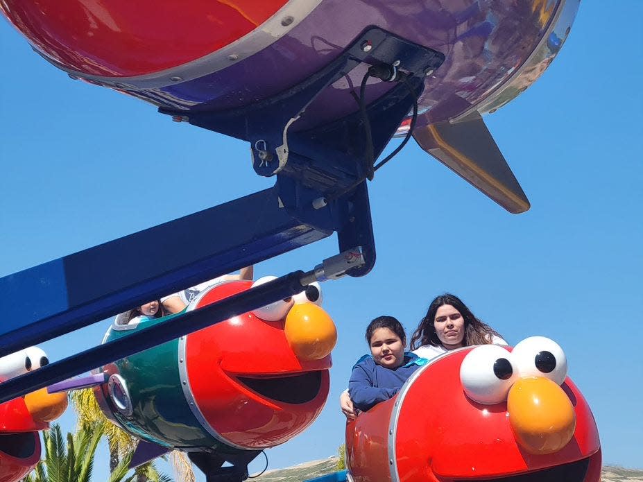 Angelo and Alena take a spin on Elmo’s Rockin’ Rockets.