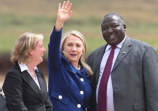 Virginia Blaser (L), Chargé d'Affaires at the US Embassy in Uganda, and Uganda's Foreign Minister Okello Oryem (R) welcome US Secretary of State Hilary Clinton. She paid tribute to a Ugandan human rights coalition working for gay rights, hours after a brief stop in Juba where she called for a compromise deal between the rival two Sudans