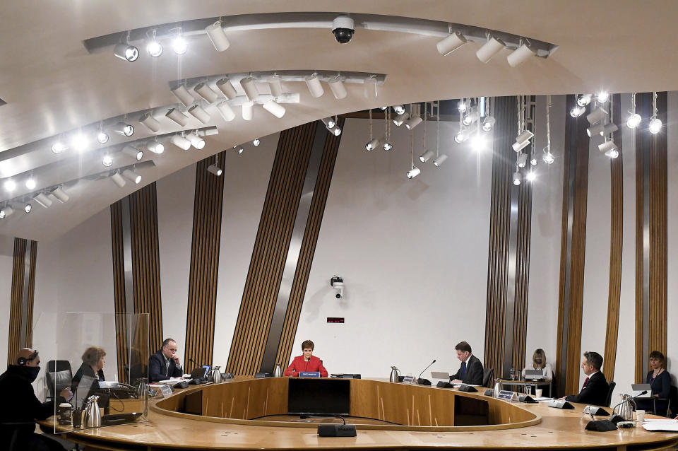 First Minister of Scotland Nicola Sturgeon, centre, gives evidence to the Committee on the Scottish Government Handling of Harassment Complaints, at Holyrood in Edinburgh, Scotland, Wednesday March 3, 2021. The inquiry is investigating the government’s handling of sexual harassment allegations against former leader Alex Salmond, and allegations that Sturgeon misled parliament. (Jeff J Mitchell/PA via AP)