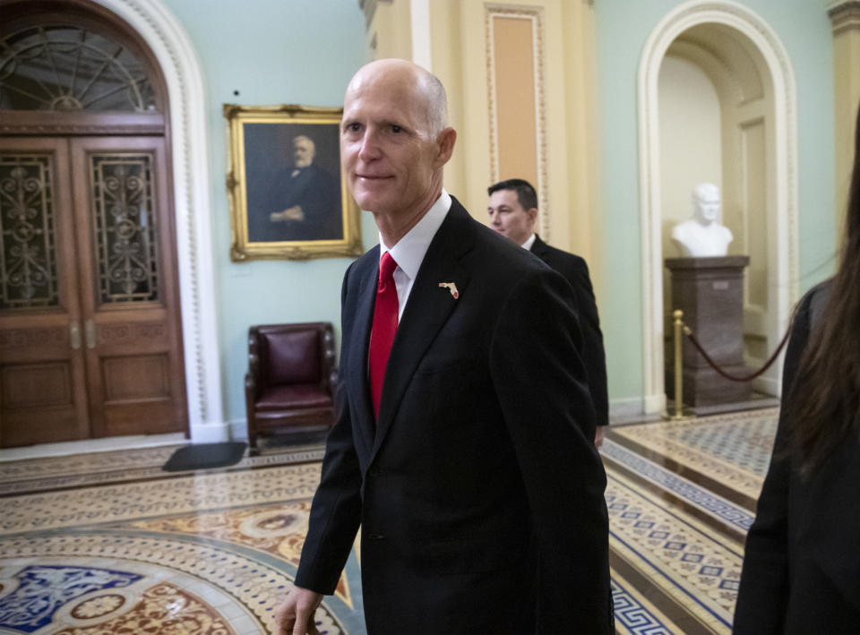 FILE- In this Wednesday, Nov. 14, 2018, file photo Florida Gov. Rick Scott arrives for a meeting with Majority Leader Mitch McConnell, R-Ky., and new GOP senators at the Capitol in Washington. Scott is leading incumbent Sen. Bill Nelson in the state’s contentious Senate race. Official results posted by the state on Sunday, Nov. 18, showed Scott ahead of Nelson following legally-required hand and machine recounts. State officials will certify the final totals on Tuesday. (AP Photo/J. Scott Applewhite, File)