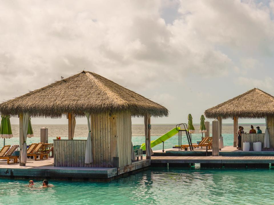 Floating cabanas at the beach in CocoCay with clouds in the background