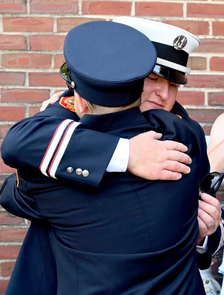 Capt. Patrick Robicheau is congratulated by a fellow firefighter following his promotion at a ceremony on July 7.