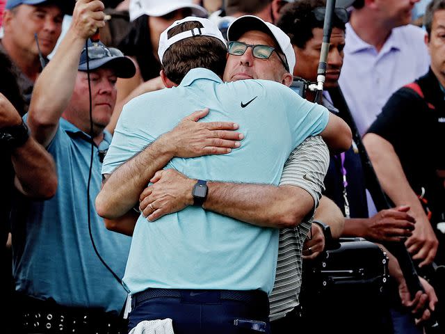 <p>James Gilbert/PGA TOUR/Getty</p> Scottie Scheffler hugs his father, Scott, after winning The Players Championship in March 2023.