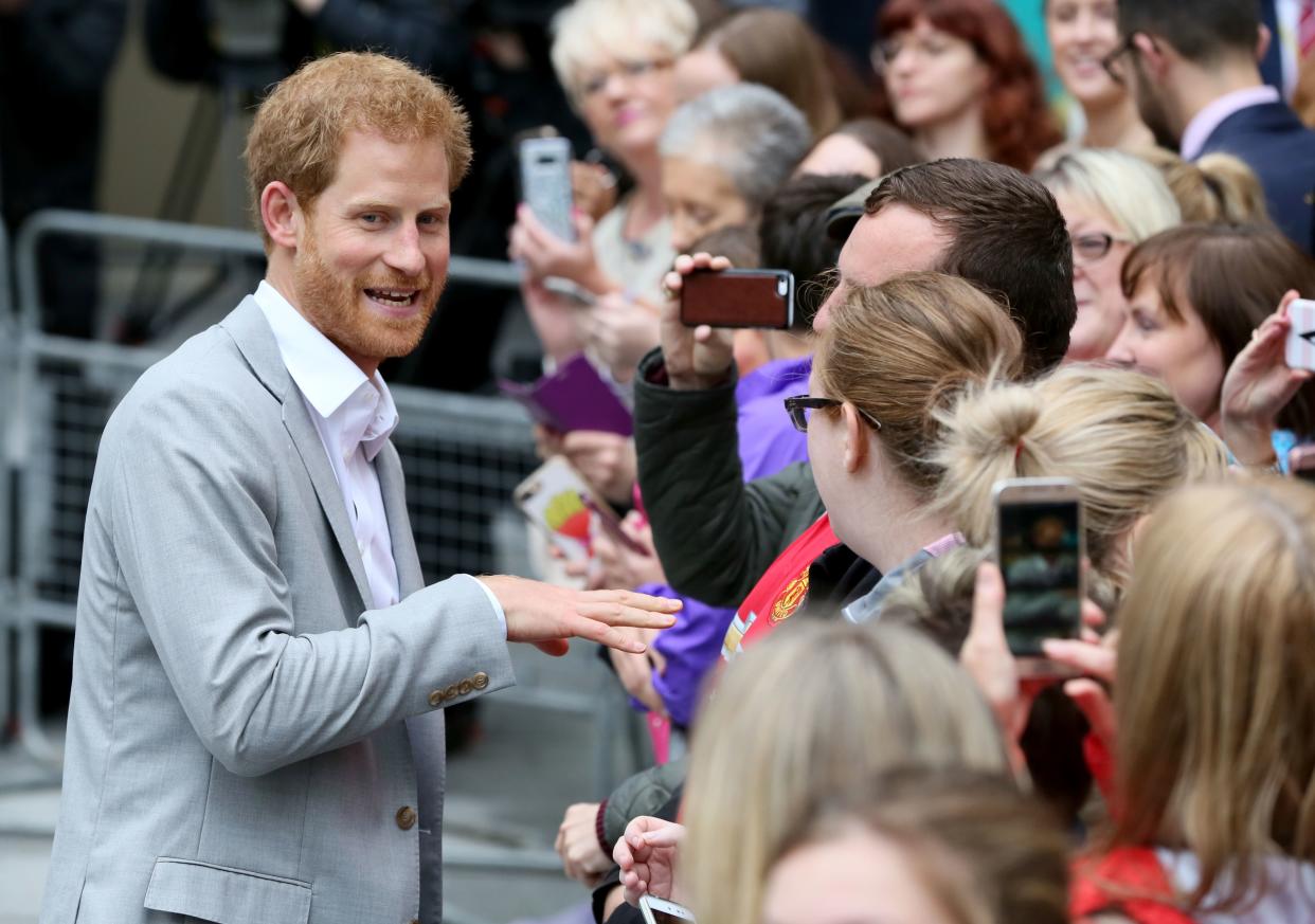 Britain's Prince Harry (L) meets people during a walkabout at the Cathedral quarter in the centre of Belfast on September 7, 2017 on his first visit to Northern Ireland. 
Prince Harry arrived in Northern Ireland for visits to Ballymena, Belfast and Hillsborough Castle during this, his first visit to the Province.  / AFP PHOTO / Paul FAITH        (Photo credit should read PAUL FAITH/AFP via Getty Images)