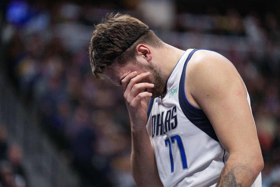 Dallas Mavericks guard Luka Doncic rubs his eye after being fouled during the first quarter of an NBA basketball game against the Denver Nuggets Monday, Dec. 18, 2023, in Denver. (AP Photo/Jack Dempsey)
