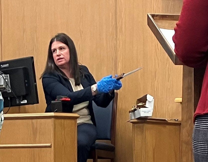 Devonie Herdeman, a DNA analyst with the Ohio Bureau of Criminal Investigation, shows the kitchen knife found in the Newark home of Debra Perrine, who was killed in December 2022.
(Credit: Kent Mallett/The Advocate)