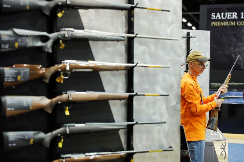 FILE PHOTO: A man inspects a Browning shotgun during the National Rifle Association (NRA) annual meeting in Indianapolis, Indiana