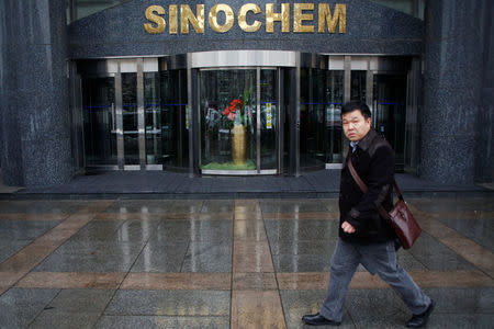 A man walks past the office building of Sinochem in Beijing, China February 21, 2017. REUTERS/Damir Sagolj