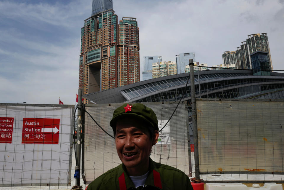 A protester dresses as People's Liberation Army (PLA) during a protest outside the Western Kowloon Station against the opening ceremony of the Hong Kong Express Rail Link in Hong Kong, Saturday, Sept. 22, 2018. Hong Kong has opened a new high-speed rail link to inland China that will vastly decrease travel times but which also raises concerns about Beijing's creeping influence over the semi-autonomous Chinese region. (AP Photo/Vincent Yu)