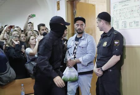Russian theatre director Kirill Serebrennikov (2nd R), who was detained and accused of embezzling state funds, is escorted inside a court building upon his arrival for a hearing on his detention in Moscow, Russia August 23, 2017. REUTERS/Tatyana Makeyeva