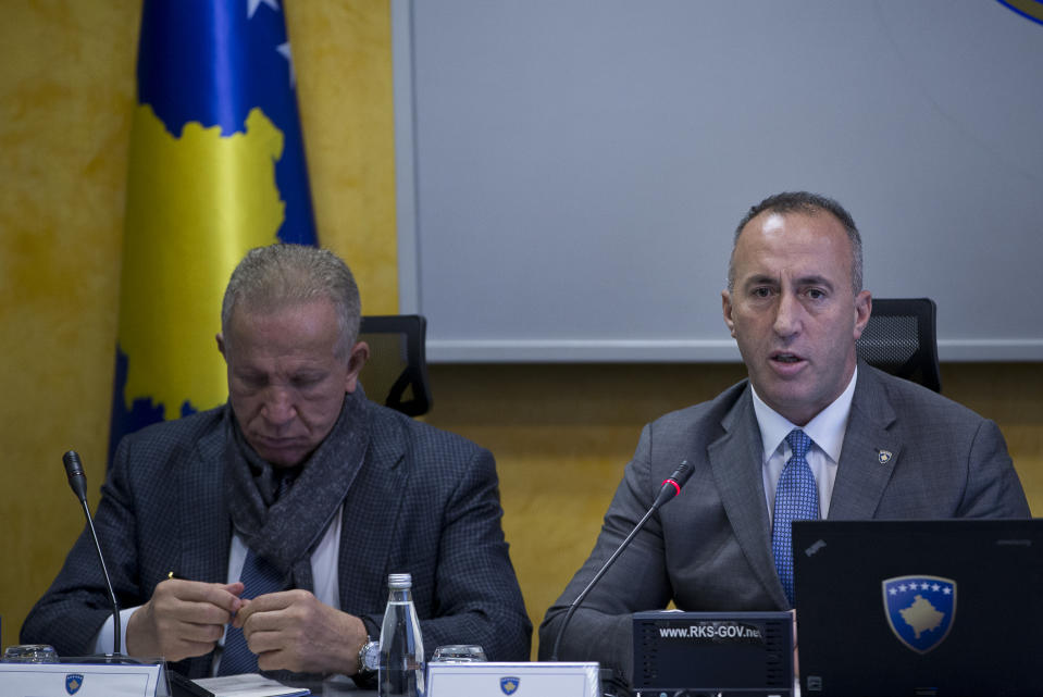 Kosovo prime minister Ramush Haradinaj, right, holds a government meeting in Kosovo capital Pristina on Tuesday, Dec. 18, 2018. Haradinaj blamed Europe Union's foreign policy chief for "deviating the dialogue" on normalizing ties with Serbia. Haradinaj said that, while Serbia is taking major steps toward the integration with the bloc, his country's residents have remained "in a ghetto," not enjoying the visa-free travel to EU countries though it has fulfilled all requirements. (AP Photo/Visar Kryeziu)