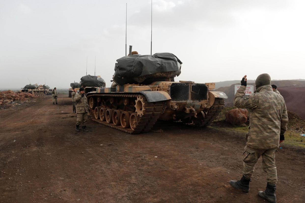 Military movement: Turkish tanks take position in a village on the Turkish-Syrian border: REUTERS