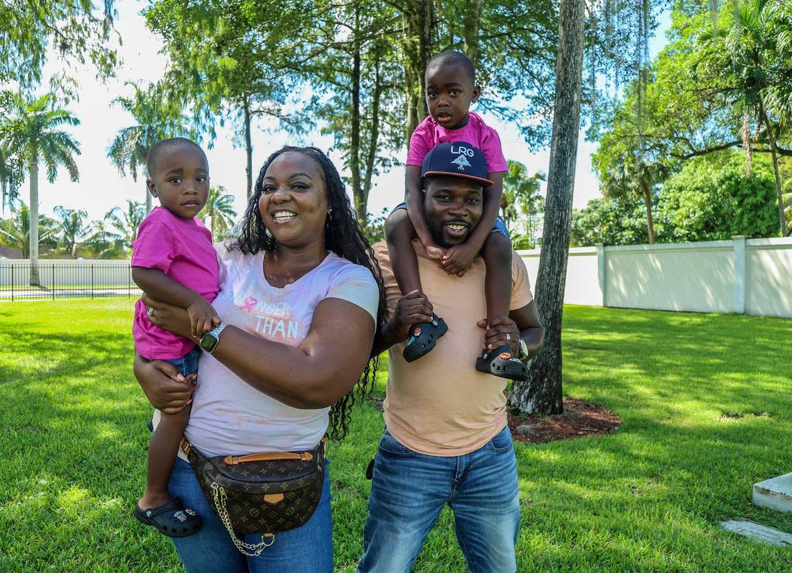 Jonise Louis holds her 2-year-old son Giovanni as her husband Milien carries their 4-year-old son Brayden at a park in Lauderhill, Florida, on Saturday, Oct. 07, 2023. Louis is a breast cancer survivor who was diagnosed during her pregnancy. She found support from other pregnant women with breast cancer.