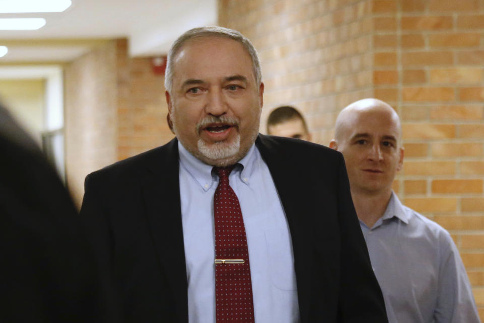 Israeli Defense Minister Avigdor Lieberman, center, arrives to the Knesset, Israel's Parliament, in Jerusalem, Wednesday, Nov. 14, 2018. Lieberman announced his resignation Wednesday over the Gaza cease-fire, making early elections likely. (AP Photo/Ariel Schalit)