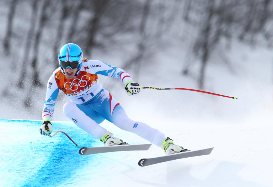 Austria's gold medalist Matthias Mayer makes a turn in the men's downhill at the Sochi 2014 Winter Olympics, Sunday, Feb. 9, 2014, in Krasnaya Polyana, Russia. (AP Photo/Alessandro Trovati)