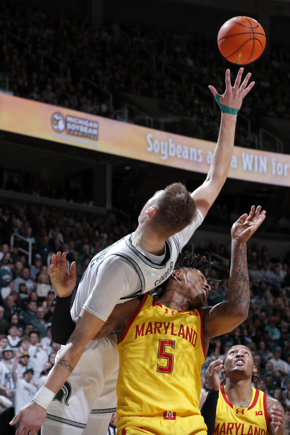 Michigan State center Carson Cooper, left, and Maryland guard DeShawn Harris-Smith (5) battle for a rebound during the second half of an NCAA college basketball game, Saturday, Feb. 3, 2024, in East Lansing, Mich. (AP Photo/Al Goldis)